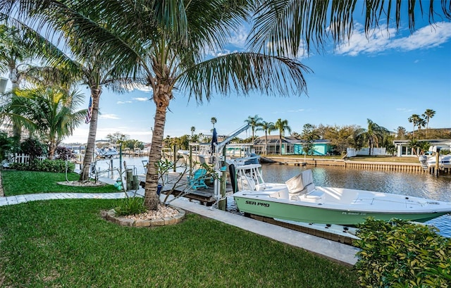 view of dock featuring a lawn, a water view, and boat lift