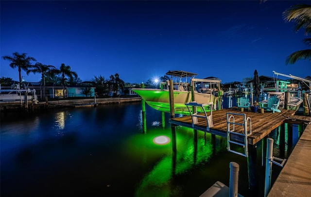 dock area with a water view and boat lift