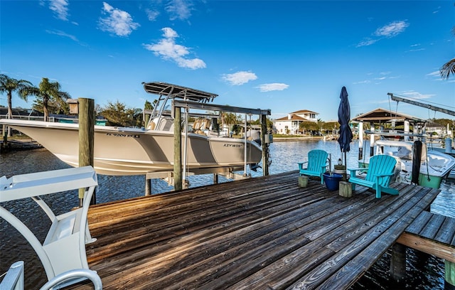 dock area with a water view and boat lift