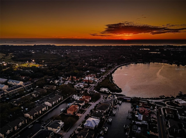 aerial view at dusk with a water view