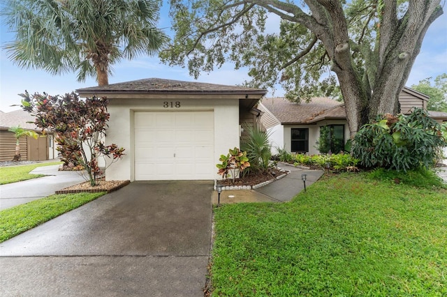 view of front of house featuring concrete driveway, a front lawn, an attached garage, and stucco siding