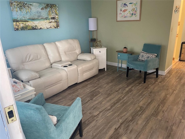 living area with baseboards and wood finished floors