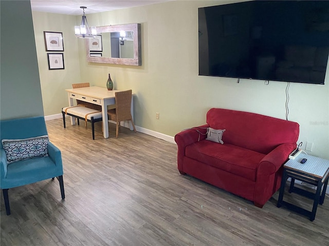 11201 80th Ave Unit 305, Seminole, FL 33772 - living room featuring baseboards and wood finished floors