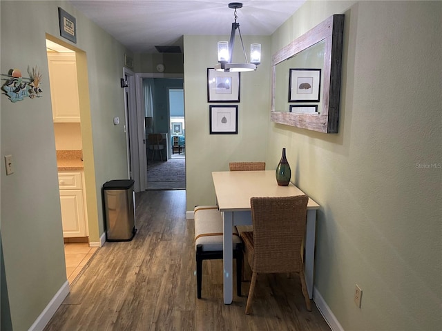 11201 80th Ave Unit 305, Seminole, FL 33772 - dining room with baseboards and wood finished floors
