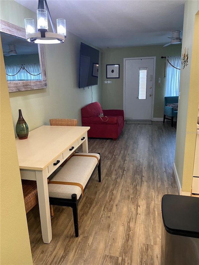11201 80th Ave Unit 305, Seminole, FL 33772 - living room with ceiling fan with notable chandelier, baseboards, and wood finished floors