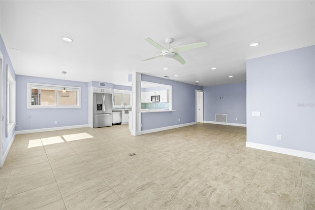 unfurnished living room featuring visible vents, recessed lighting, baseboards, and ceiling fan