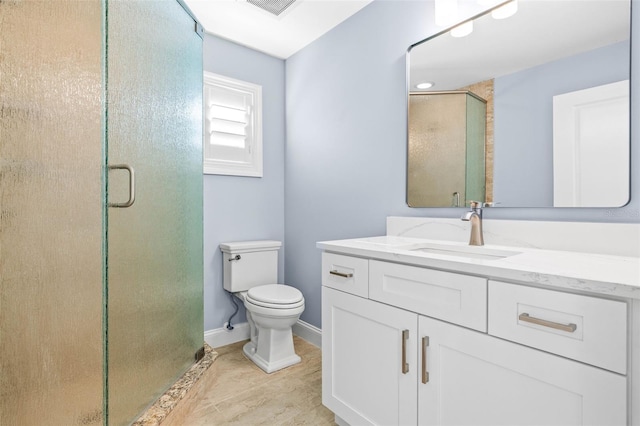 full bath with vanity, a shower stall, toilet, and baseboards