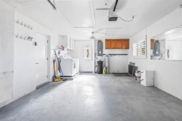 garage featuring electric panel, separate washer and dryer, and a garage door opener