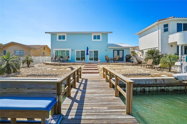 330 176th Avenue Cir, Redington Shores, FL 33708 - rear view of house featuring a patio, metal roof, fence, and stucco siding
