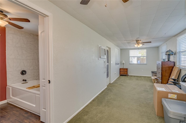 interior space featuring carpet flooring, baseboards, and ceiling fan