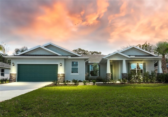 craftsman house featuring stucco siding, a lawn, a garage, stone siding, and driveway