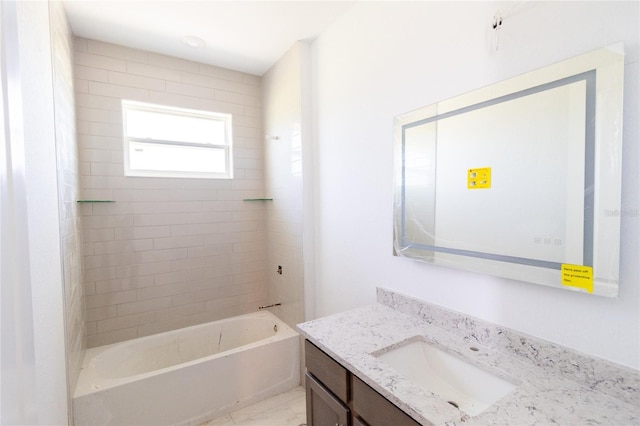 bathroom with marble finish floor, shower / bathing tub combination, and vanity