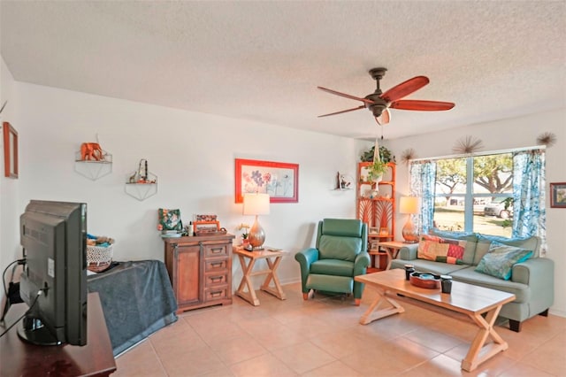 living room featuring light tile patterned flooring, a textured ceiling, and a ceiling fan