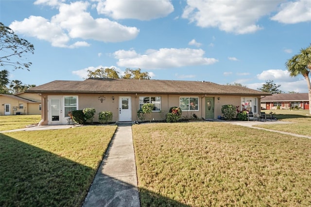 ranch-style house featuring stucco siding, a patio, and a front lawn