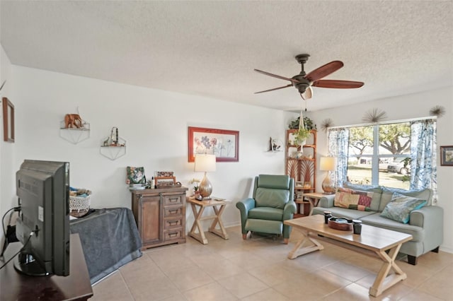 living room with light tile patterned flooring, a textured ceiling, and a ceiling fan