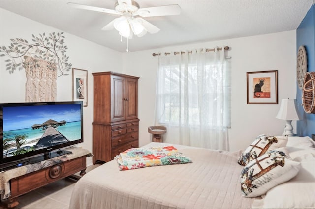 tiled bedroom with a ceiling fan