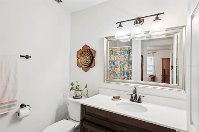 bathroom featuring vanity and toilet