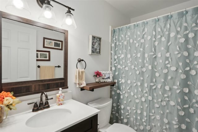 bathroom with vanity, a shower with shower curtain, and toilet