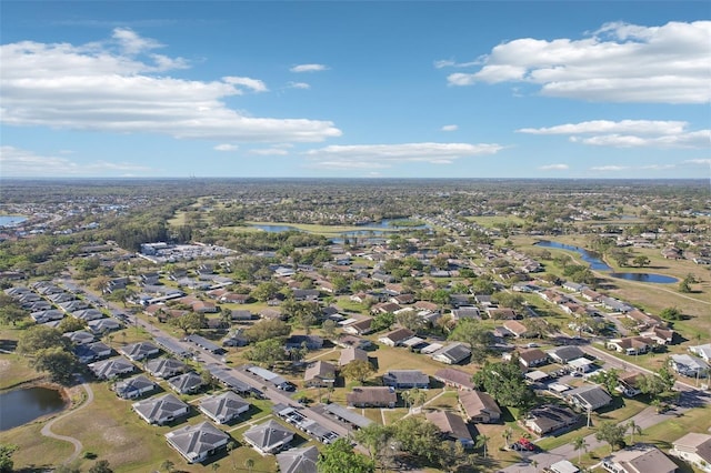 drone / aerial view with a water view and a residential view