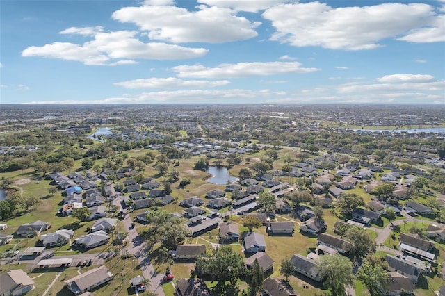 drone / aerial view featuring a water view and a residential view