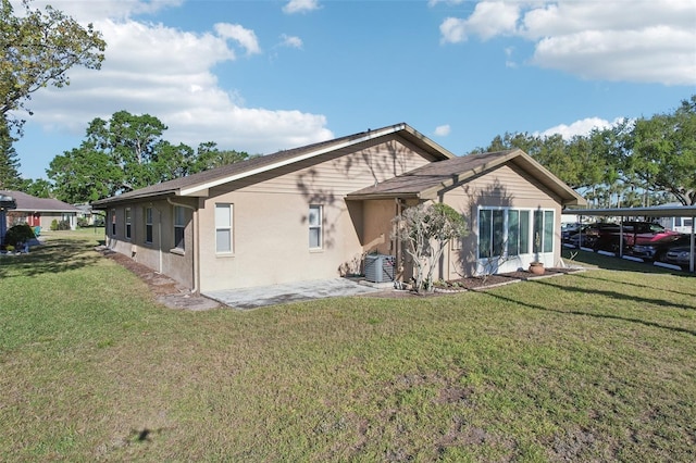 back of house featuring a patio area, stucco siding, and a yard