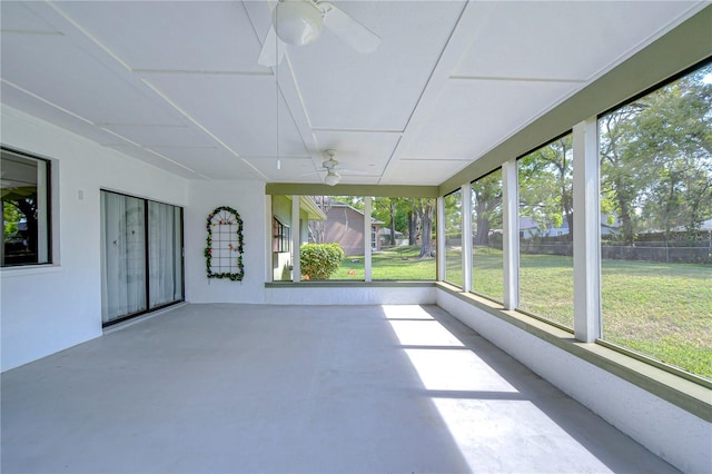 unfurnished sunroom featuring ceiling fan