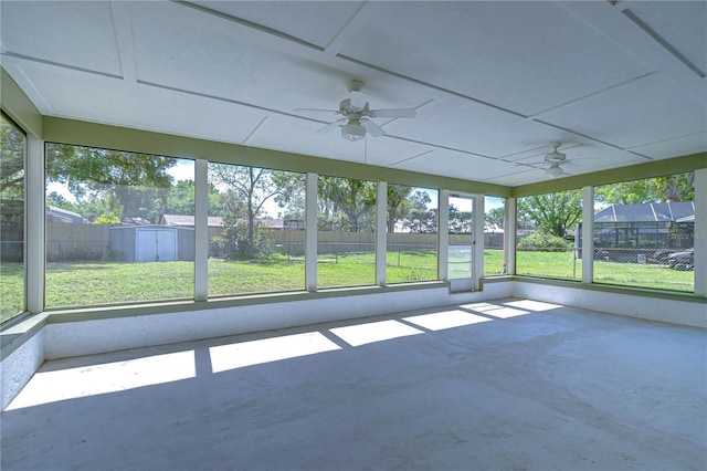 unfurnished sunroom featuring ceiling fan