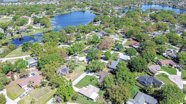 drone / aerial view featuring a residential view and a water view