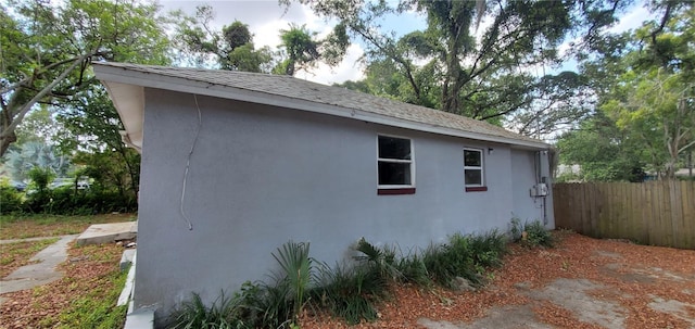 view of home's exterior featuring fence and stucco siding