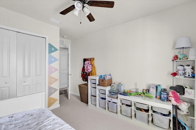 bedroom featuring a ceiling fan, visible vents, carpet, and a closet