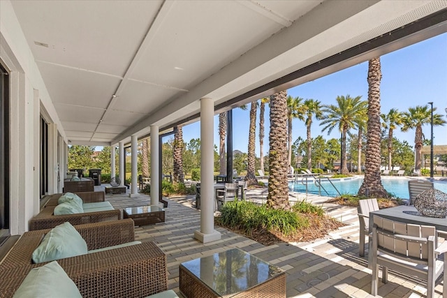 view of patio with an outdoor living space and a community pool