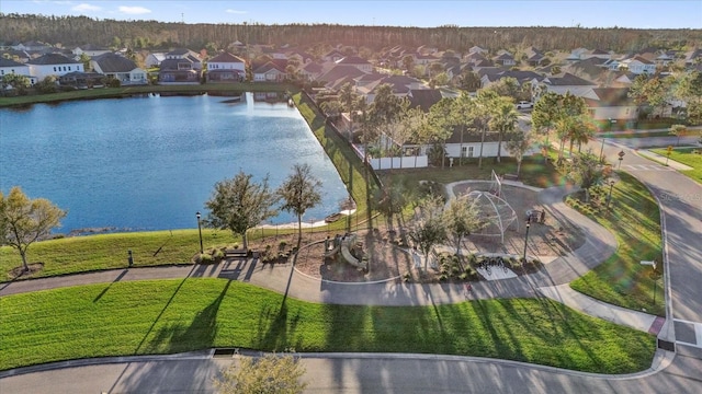 drone / aerial view with a residential view and a water view