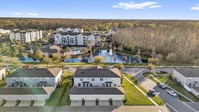 birds eye view of property featuring a residential view, a view of trees, and a water view