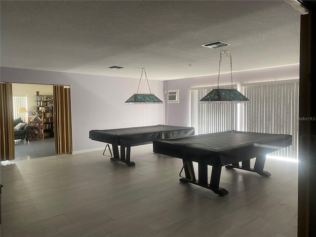 rec room featuring visible vents, pool table, a textured ceiling, and wood finished floors