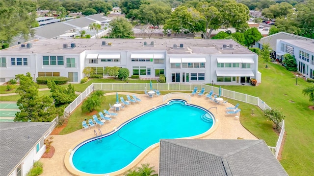 community pool with a residential view, a patio, and fence