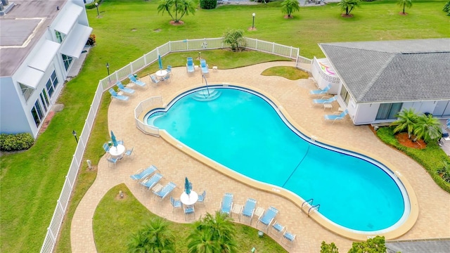 pool featuring a yard, a patio area, and a fenced backyard