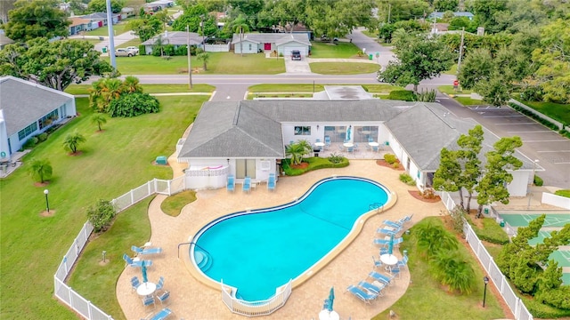 community pool featuring a patio area, a residential view, and fence