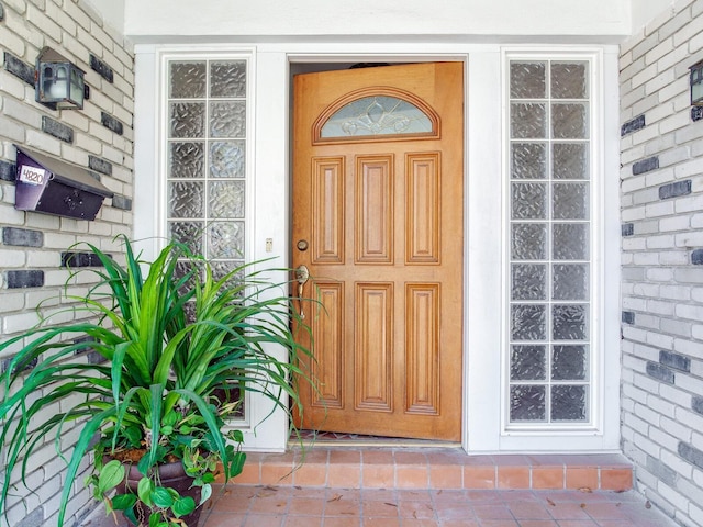 entrance to property with brick siding