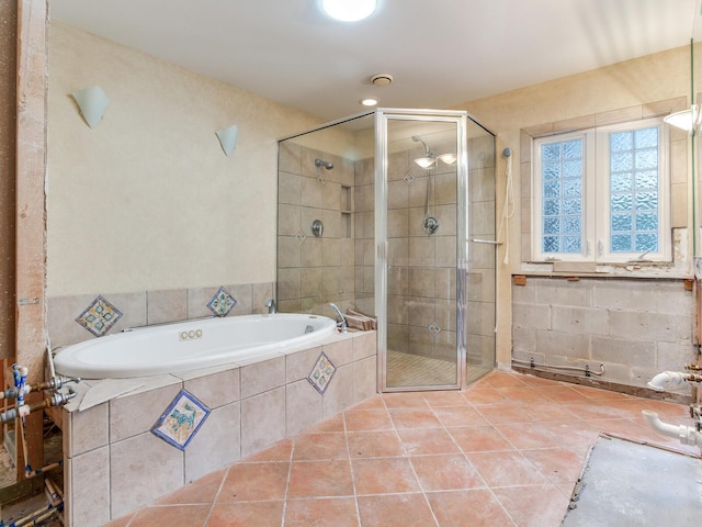 full bath with tile patterned floors, a garden tub, and a shower stall