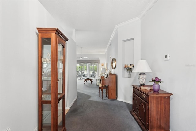 corridor featuring baseboards, carpet, and ornamental molding