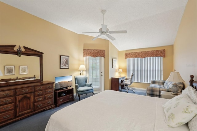 bedroom featuring multiple windows, ceiling fan, dark carpet, and vaulted ceiling