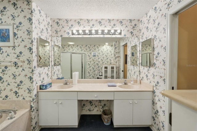 full bath featuring wallpapered walls, a shower stall, a sink, and a textured ceiling