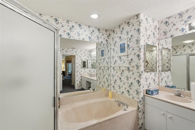 full bath with a garden tub, a textured ceiling, a shower stall, and wallpapered walls