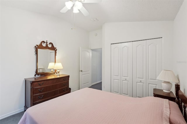 bedroom featuring a closet, dark colored carpet, baseboards, ceiling fan, and vaulted ceiling