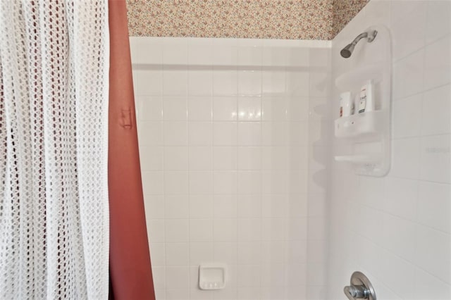 bathroom with walk in shower and wallpapered walls