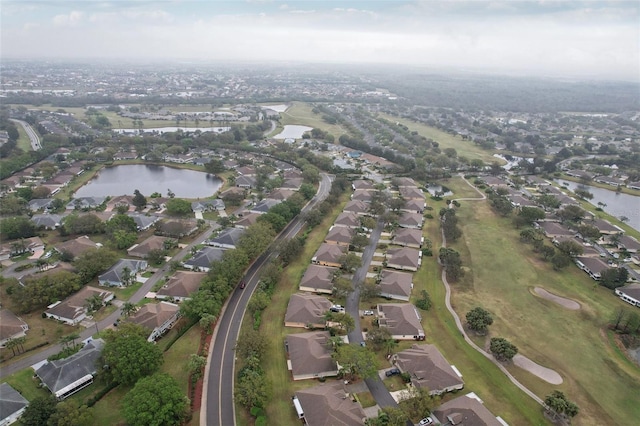 drone / aerial view featuring a residential view and a water view