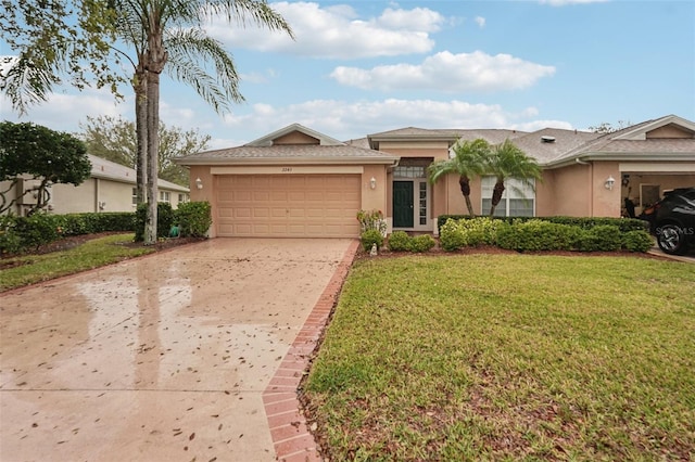 ranch-style home with concrete driveway, an attached garage, a front yard, and stucco siding