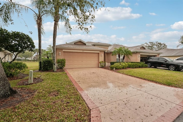 ranch-style home featuring stucco siding, a garage, concrete driveway, and a front lawn