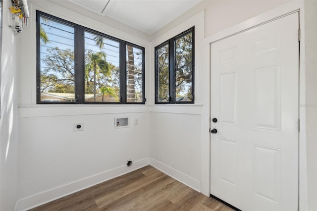 laundry area featuring laundry area, baseboards, wood finished floors, washer hookup, and electric dryer hookup