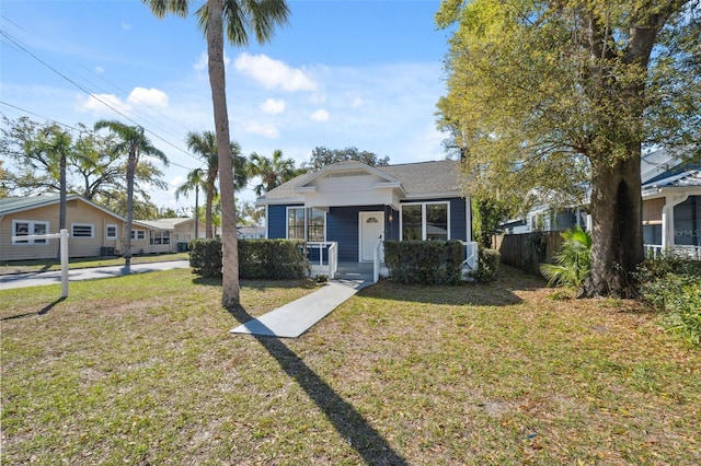 bungalow-style house featuring a front lawn and fence